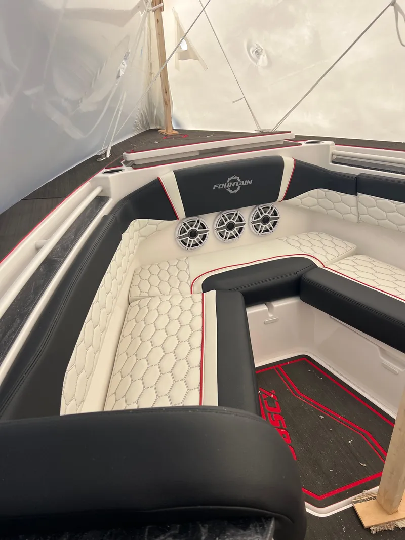 Slide: The Image of 2025 Fountain 38 SCX boat interior with hexagonal-patterned seating and built-in speakers. - 24
