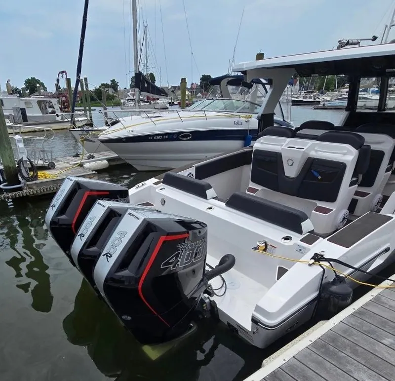 Slide: The Image of 2025 Fountain 38SCX boat with triple outboard engines docked at a marina. - 3
