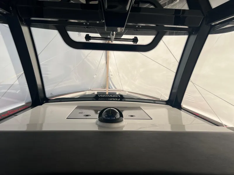 Slide: The Image of Interior view of 2025 Fountain 38 SCX boat cockpit with windshield and compass. - 31