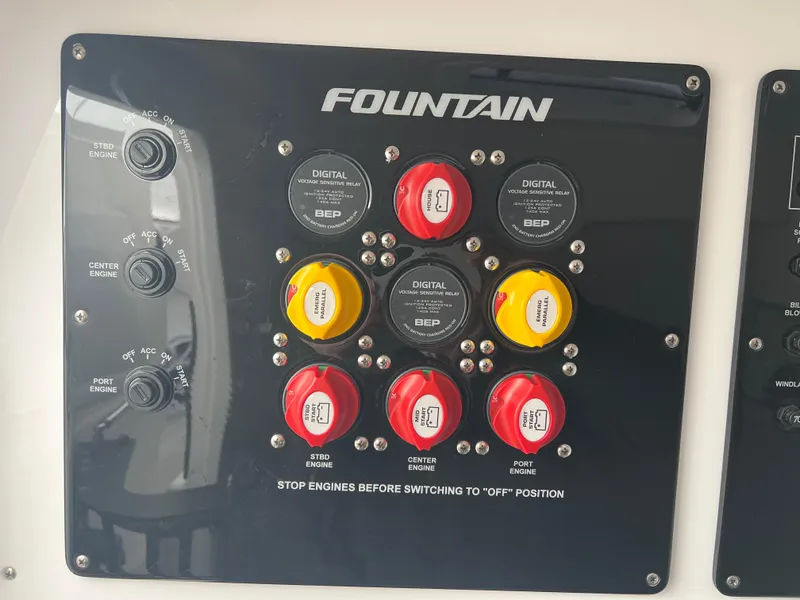 Slide: The Image of Control panel of 2025 Fountain 38 SCX boat with labeled switches and dials. - 35
