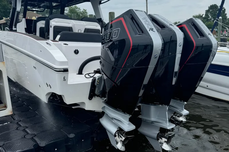 Slide: The Image of 2025 Fountain 38SCX boat with triple outboard engines docked at marina. - 7