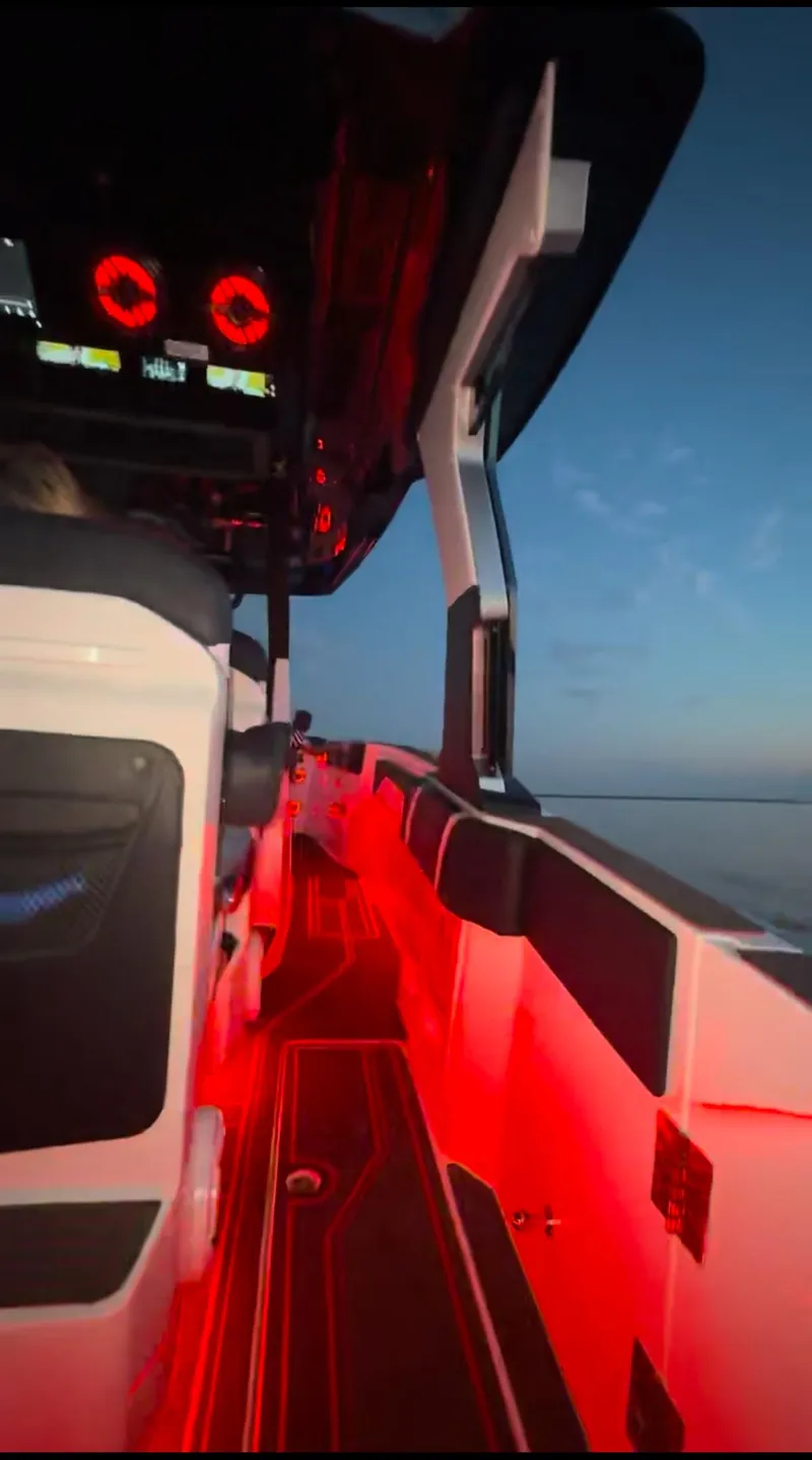 Slide: The Image of 2025 Fountain 38SCX boat interior with red LED lighting at dusk. - 9
