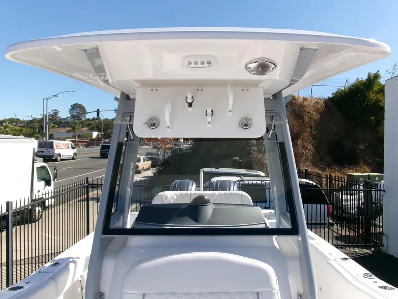 Slide: The Image of 2025 Sea Fox 268 Commander boat with T-top and windshield, parked outdoors. - 15