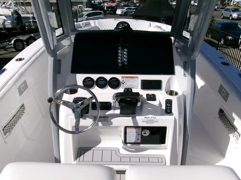 Slide: The Image of 2025 Sea Fox 268 Commander boat cockpit with steering wheel and control panel. - 19