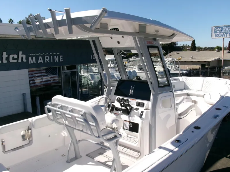 Slide: The Image of 2025 Sea Fox 268 Commander boat at a marina, showcasing helm and seating area. - 21
