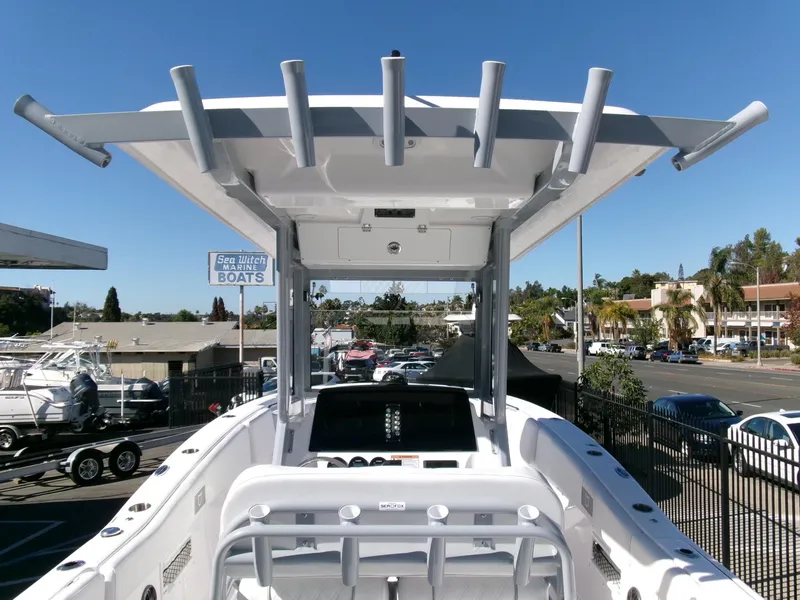Slide: The Image of 2025 Sea Fox 268 Commander boat, view of helm and T-top in a marina setting. - 22