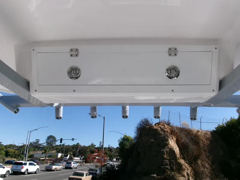 Slide: The Image of 2025 Sea Fox 268 Commander storage compartment with rod holders, viewed from below. - 24