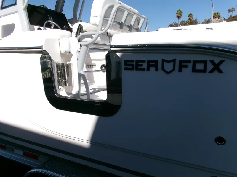 Slide: The Image of 2025 Sea Fox 268 Commander boat, white exterior, partial view with seating and logo. - 44