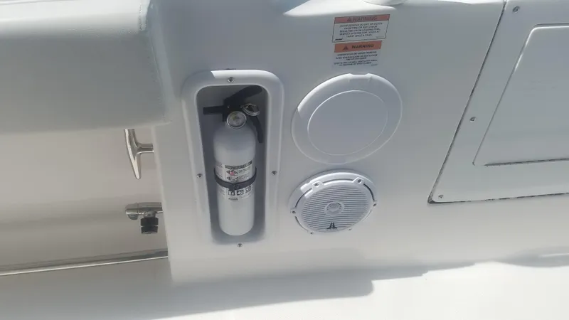 Slide: The Image of Fire extinguisher and speaker on 2018 Edgewater 320 CC boat interior. - 16