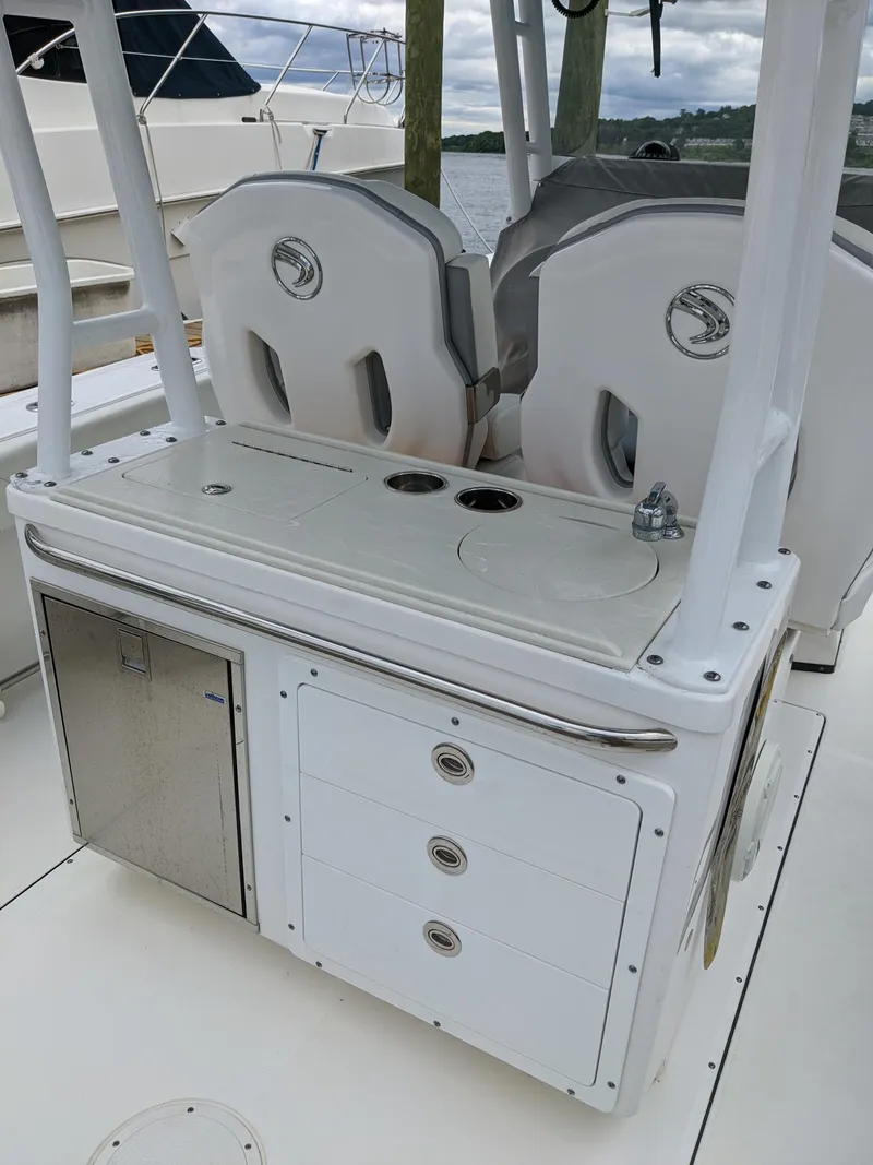 Slide: The Image of 2018 Edgewater 320 CC boat interior with storage and seating. - 19