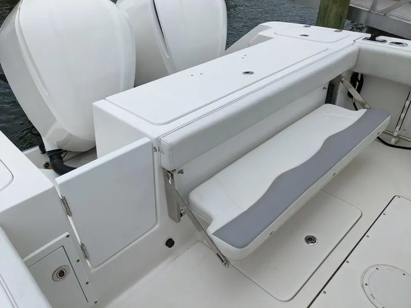Slide: The Image of 2018 Edgewater 320 CC boat with foldable seating and dual outboard engines. - 23