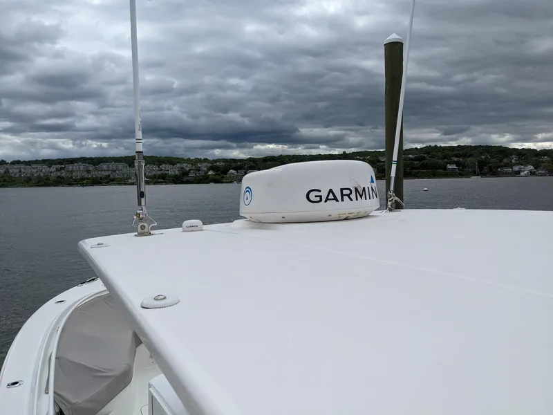 Slide: The Image of 2018 Edgewater 320 CC boat with Garmin radar on a cloudy day. - 25