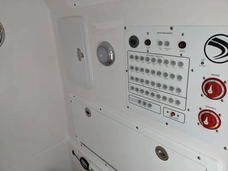 Slide: The Image of Control panel of a 2018 Edgewater 320 CC boat, featuring switches and dials. - 28