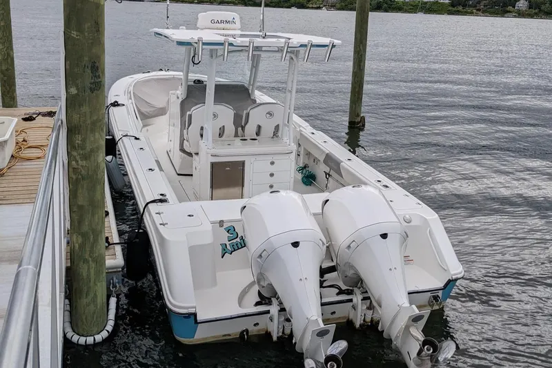 Slide: The Image of 2018 Edgewater 320 CC boat docked with twin outboard engines. - 3