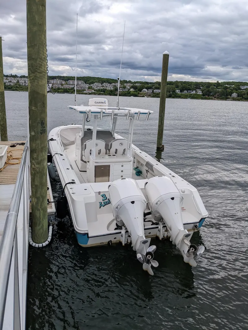 Slide: The Image of 2018 Edgewater 320 CC boat docked on a cloudy day. - 4