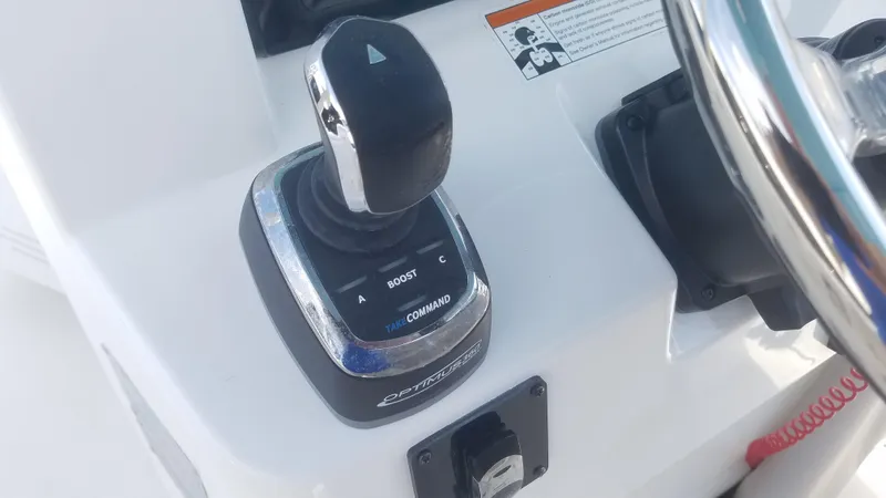 Slide: The Image of Close-up of 2018 Edgewater 320 CC boat throttle control and steering wheel. - 7