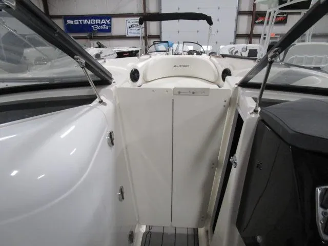 Slide: The Image of 2017 Larson 292 LXI boat interior with open cockpit and seating area. - 10