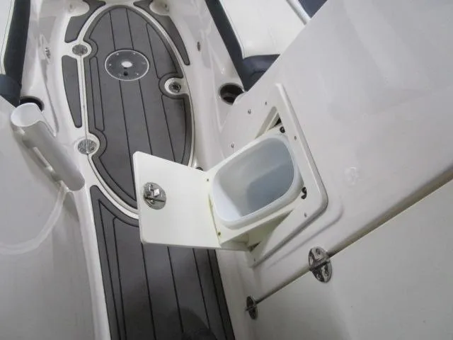 Slide: The Image of 2017 Larson 292 LXI boat interior with open storage compartment. - 11