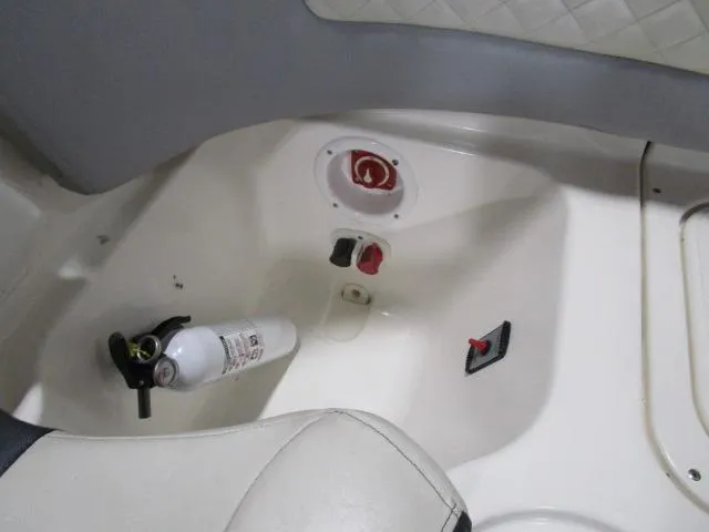 Slide: The Image of Interior of 2017 Larson 292 LXI boat with fire extinguisher and control panel. - 12