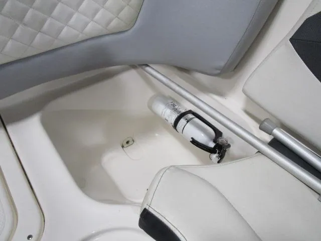 Slide: The Image of 2017 Larson 292 LXI boat interior with fire extinguisher and white seating. - 13