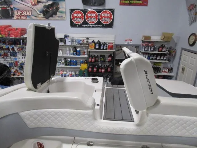 Slide: The Image of 2017 Larson 292 LXI boat interior with open storage, in a marine supply store. - 15