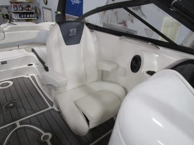 Slide: The Image of 2017 Larson 292 LXI boat interior with white seating and modern design. - 16