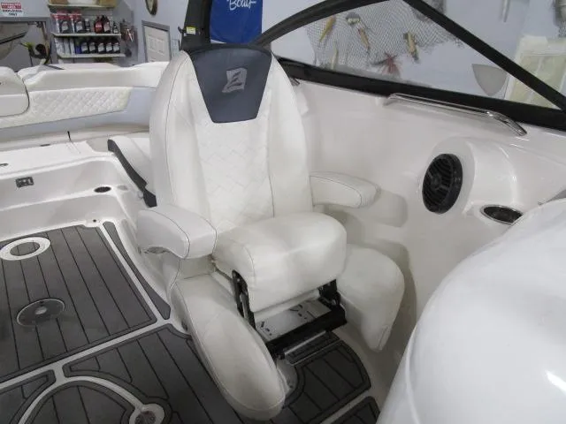 Slide: The Image of 2017 Larson 292 LXI boat interior with white captain's chair and sleek design. - 18