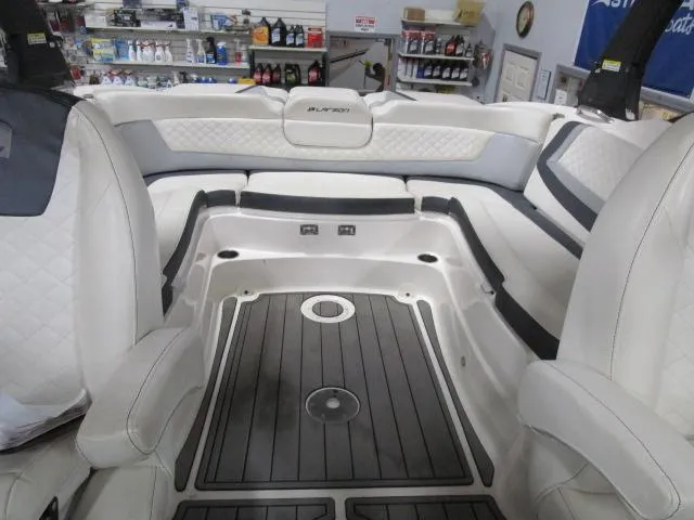 Slide: The Image of Interior of 2017 Larson 292 LXI boat with white seating and black flooring. - 20