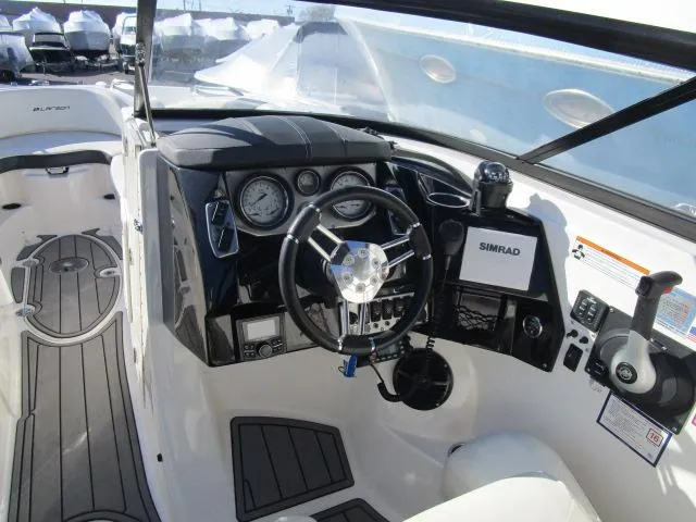 Slide: The Image of 2017 Larson 292 LXI boat interior with steering wheel and dashboard controls. - 31