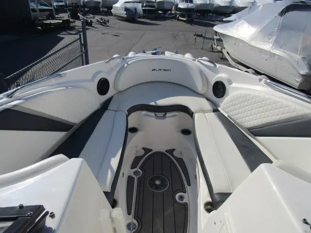 Slide: The Image of 2017 Larson 292 LXI boat interior with white seating and black accents. - 32