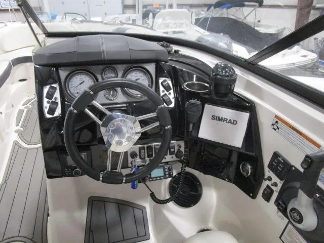 Slide: The Image of Cockpit of 2017 Larson 292 LXI boat with steering wheel and navigation instruments. - 5