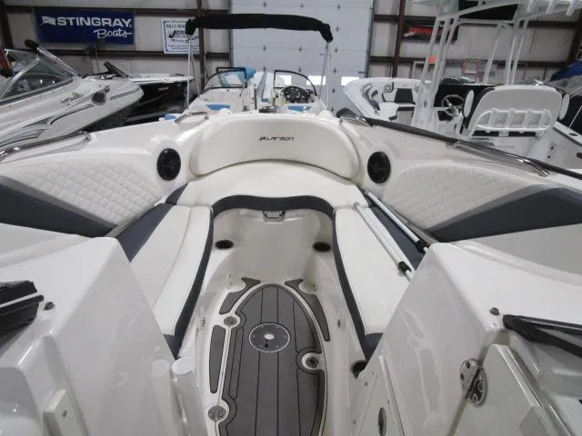 Slide: The Image of 2017 Larson 292 LXI boat interior with white seating and modern design. - 6