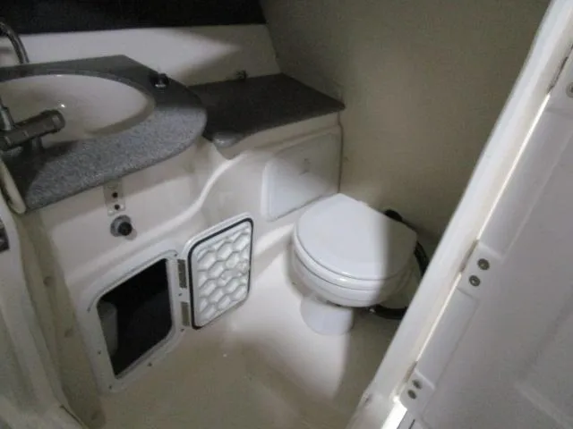 Slide: The Image of Compact bathroom in 2017 Larson 292 LXI boat with sink and toilet. - 7