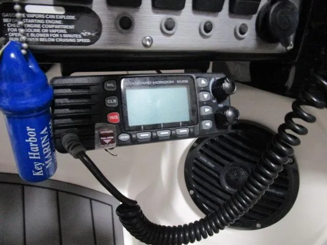 Slide: The Image of Close-up of a 2017 Larson 292 LXI boat's control panel with radio and speaker. - 9