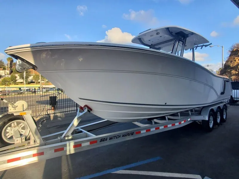 Slide: The Image of 2025 Sea Fox 288 Commander boat on trailer, parked outdoors under blue sky. - 2