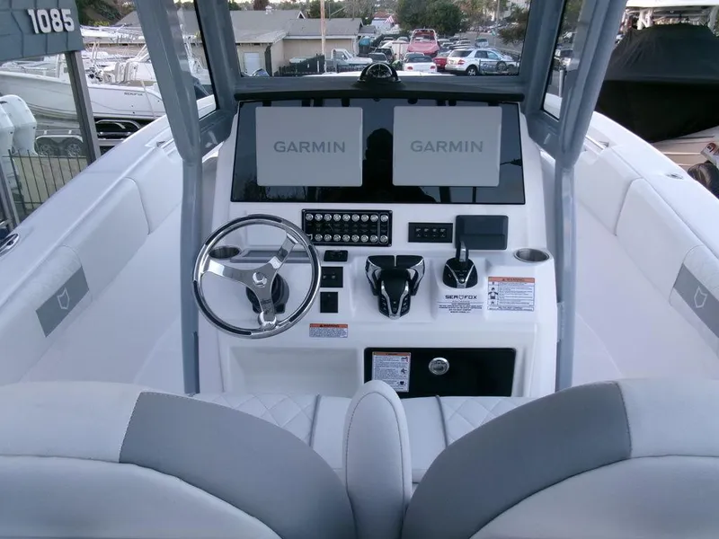 Slide: The Image of 2025 Sea Fox 288 Commander boat dashboard with Garmin displays and modern controls. - 23