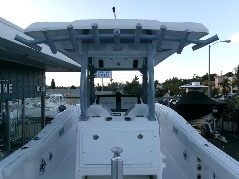Slide: The Image of 2025 Sea Fox 288 Commander boat, view of helm and T-top in marina setting. - 29
