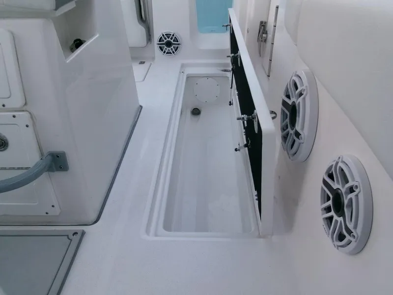 Slide: The Image of 2025 Sea Fox 288 Commander boat interior with open storage compartment and speakers. - 37