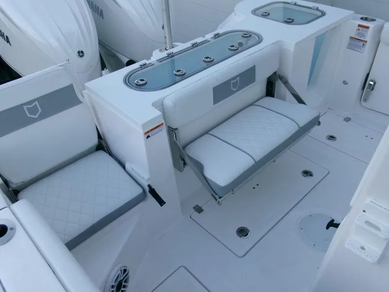 Slide: The Image of 2025 Sea Fox 288 Commander boat interior with white seating and storage compartments. - 39