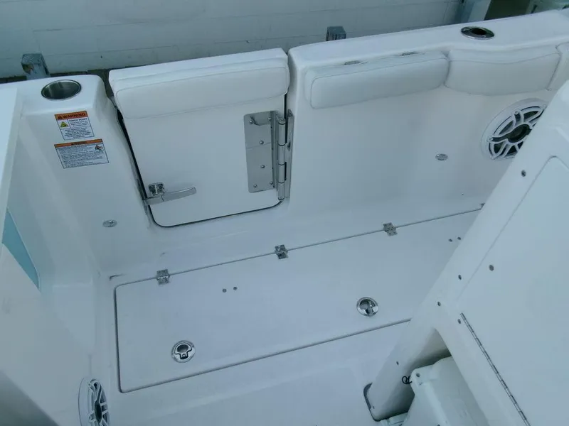 Slide: The Image of 2025 Sea Fox 288 Commander boat interior, featuring white seating and storage compartments. - 43