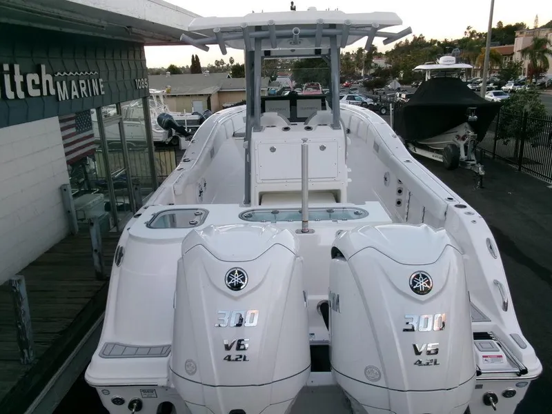 Slide: The Image of 2025 Sea Fox 288 Commander boat with dual Yamaha 300 V6 engines at a marina. - 47