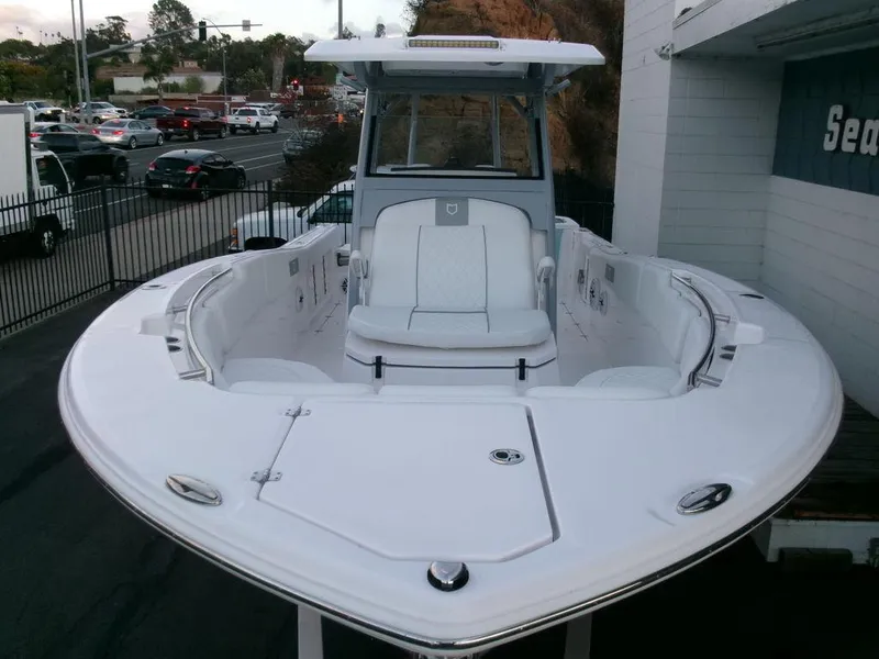 Slide: The Image of 2025 Sea Fox 288 Commander boat, sleek white design, parked outdoors. - 48