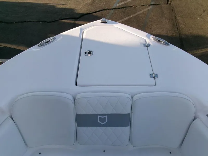 Slide: The Image of 2025 Sea Fox 288 Commander boat bow with cushioned seating and storage hatch. - 5