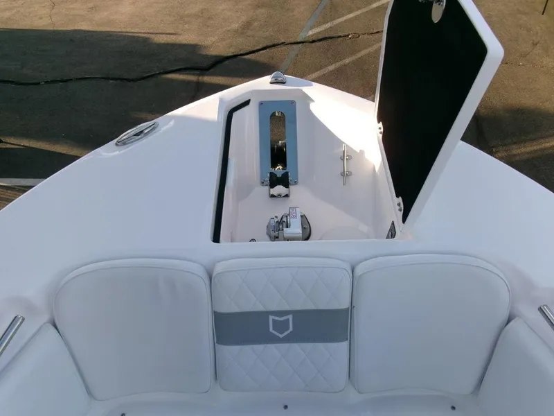 Slide: The Image of 2025 Sea Fox 288 Commander boat anchor compartment with open hatch and cushioned seating. - 6