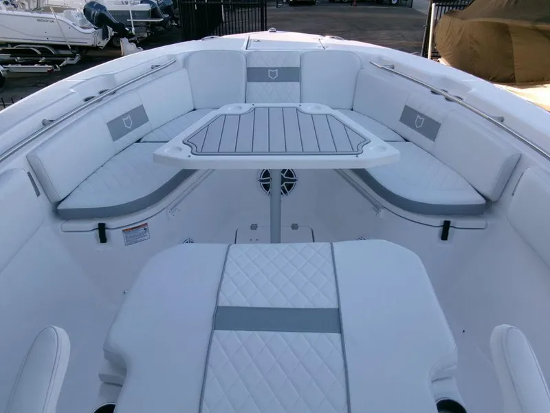Slide: The Image of 2025 Sea Fox 288 Commander boat interior with cushioned seating and table. - 9