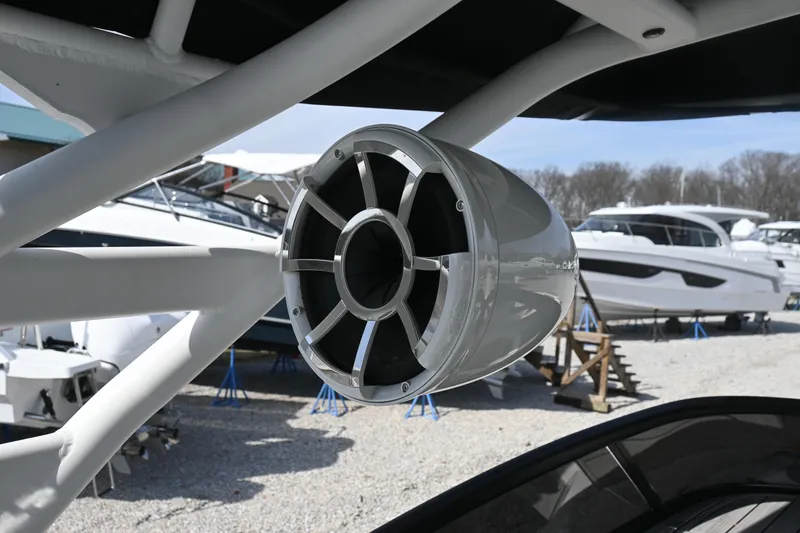 Slide: The Image of 2023 Yamaha Boats 252SD speaker detail in marina setting. - 17