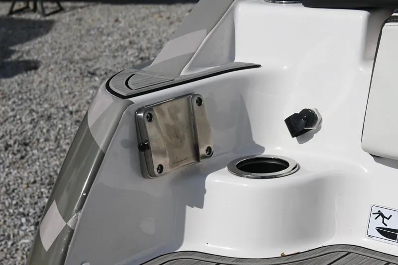 Slide: The Image of 2023 Yamaha Boats 252SD, rear deck detail with stainless steel fittings and cup holder. - 20