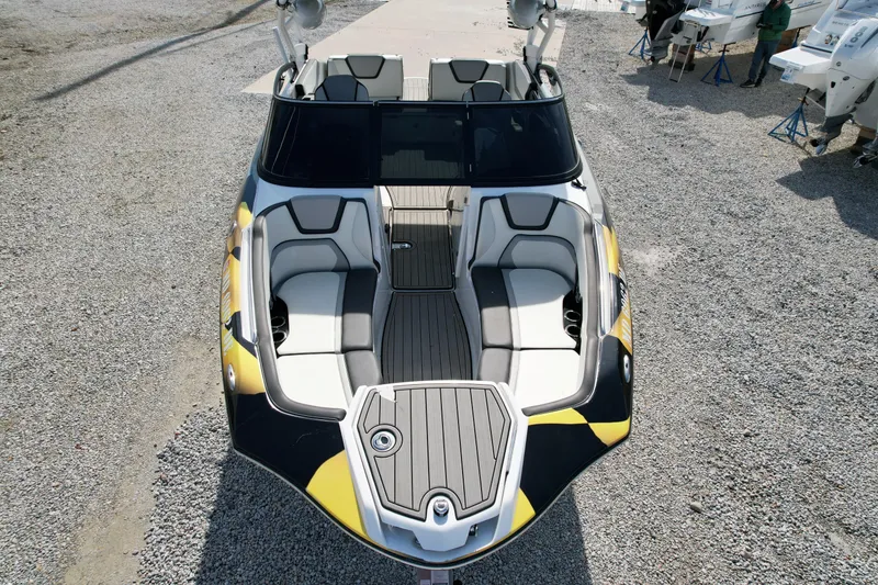 Slide: The Image of 2023 Yamaha Boats 252SD, sleek design, spacious seating, modern features, docked on gravel. - 5