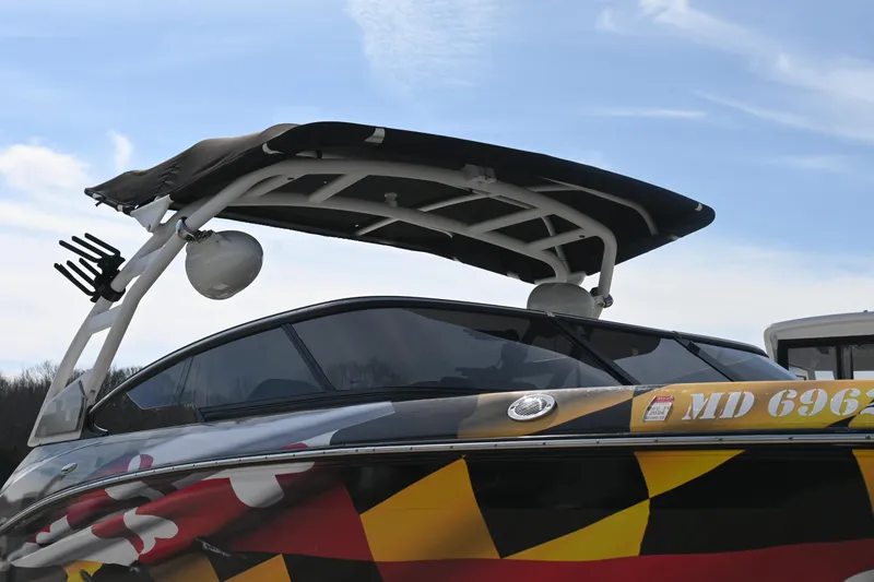 Slide: The Image of 2023 Yamaha Boats 252SD with colorful design and sleek canopy against a clear sky. - 9