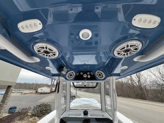 Slide: The Image of 2025 Sportsman Heritage 261 boat interior with blue ceiling and built-in speakers. - 11